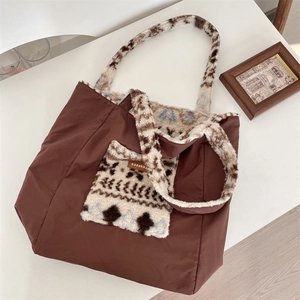 Detail of vintage tote bag featuring brown fabric and plush geometric patterned pocket