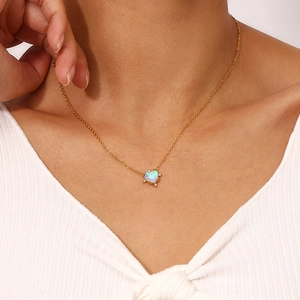 Detailed view of heart-shaped opal pendant on gold-plated stainless steel chain