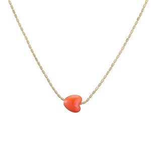 Fashionable golden bamboo chain necklace featuring a vibrant orange heart ceramic pendant
