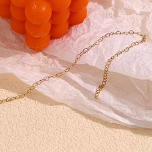 Detailed view of 14K gold plated stainless steel heart link chain on textured background