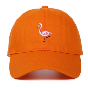 Close-up of fine flamingo embroidery on an orange cotton twill baseball cap fabric