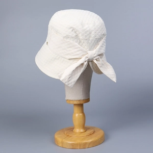 Elegant white waffle knit sun hat for women featuring a large decorative rear bow