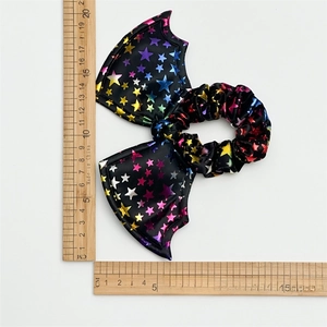 Halloween black oversized bow scrunchie with metallic stars and size measurement tool
