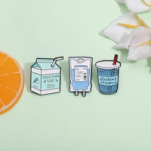 Chic milk carton and infusion bag enamel pins set on a fresh green background