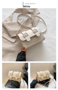 Detail of off-white minimalist crossbody bag with double buckle flap and slim strap