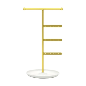 Detail of golden metal jewelry rack with white tray base for earrings and necklaces