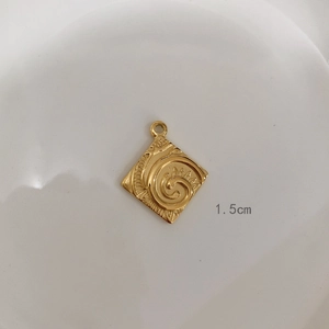 Macro view of 1.5cm square gold pendant with embossed spiral texture and bail