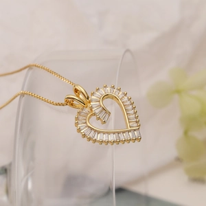 Gold plated heart pendant necklace with baguette-cut zircons on a box chain for women