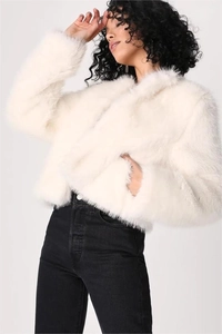Close-up of fluffy white faux fur texture and premium soft material of the short coat