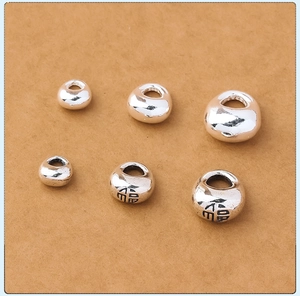 Close-up of three sizes of s925 solid silver bead pendants with Chinese Fu character