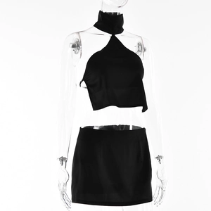 Detail view of a black halter crop top and mini skirt set on a mannequin