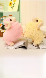 Detail of pink and yellow plush sheep toys with soft curly horns in a cozy setting
