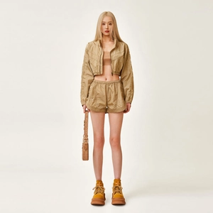 Close-up of khaki women's short stand collar jacket and matching athletic shorts