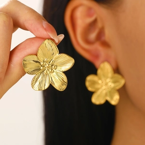 Vintage golden stainless steel five-petal flower earrings worn by a female model