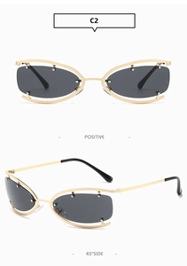 Front and 45-degree side view of rimless oval sunglasses with gold frames and dark grey lenses