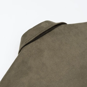 Detailed close-up of faux suede jacket collar and shoulder with premium stitching texture