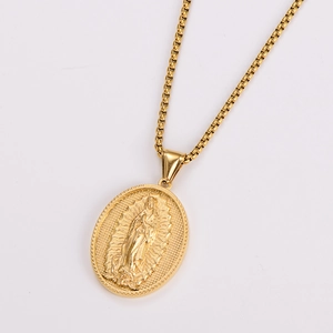 Detailed close-up of gold tone Virgin Mary Guadalupe pendant on box chain necklace