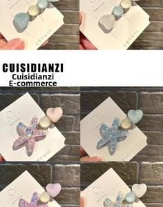 Detail view of heart and star hair clips in macaron colors with glitter finish