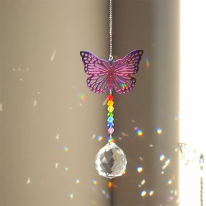 Detail of metal purple butterfly suncatcher with rainbow beads and faceted crystal prism