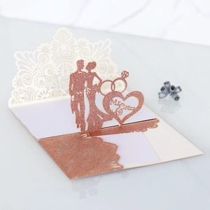 Detailed laser-cut rose gold wedding card with 3D pop-up Mr & Mrs silhouette design