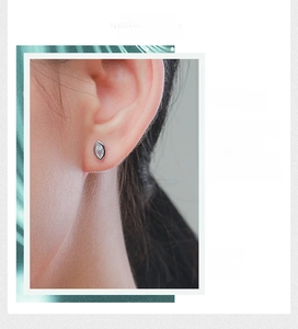 Macro detail of marquise cut cubic zirconia stud earring worn on model ear