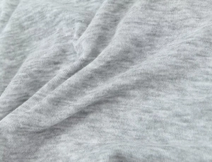Close-up macro view of high-quality grey cotton knit fabric texture with soft folds