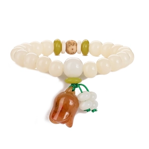 Detailed shot of white Bodhi seed beads with green spacers and amber lotus charm pendant