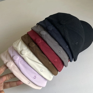 Stack of colorful cotton baseball caps with star embroidery showing various color options