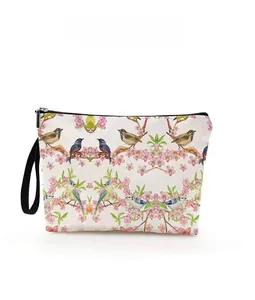 Detailed pattern display of floral and kingfisher bird print on a zip cosmetic bag