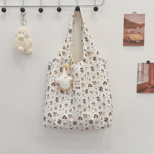 Detail of white quilted tote bag with cartoon patterns and zakka beaute label