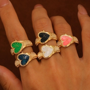 Vintage heart watch rings in five colors with golden bands on a dark background