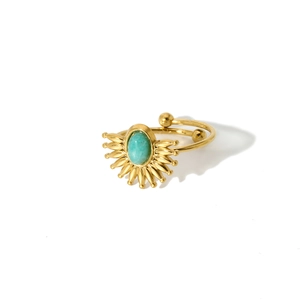 Detail of starburst gold ring with turquoise stone and adjustable open band