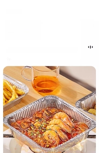 Disposable food-grade aluminum foil tray used for grilling seafood over an open flame