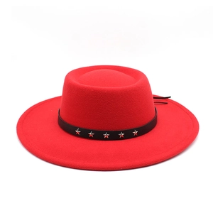 Detail of red wool fedora with black leather band and silver star rivets on the rim