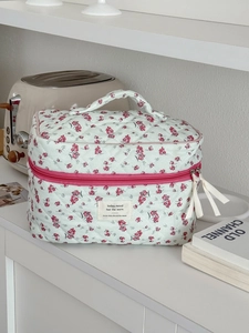Floral corduroy cosmetic bag with quilted green fabric and pink zipper for travel storage