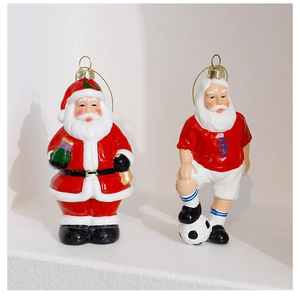 Detail of Santa Claus ornaments with glossy ceramic finish and golden hanging strings