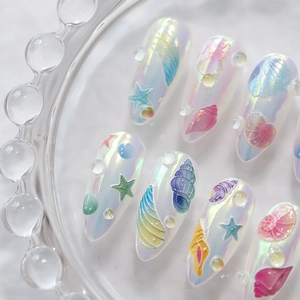 3D ocean-themed pearlescent press-on nails with seashell, starfish, and 3D water drop accents