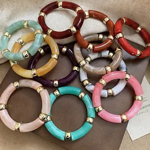Iridescent acrylic bamboo link bracelets in colorful resin with gold spacer rings