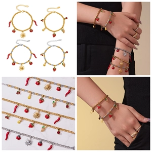Detailed view of 18k gold plated beaded bracelets with enamel chili and fruit charms