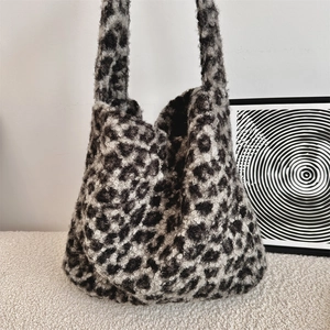 Detail of leopard print faux shearling tote bag showing plush texture and shoulder straps