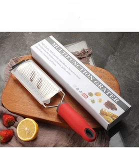 Detail showing 18/8 stainless steel cheese grater with red handle on wooden board