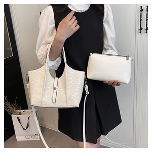 Detail view of cream-white tote bag with letter print and matching inner pouch