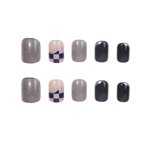Short round translucent black checkerboard press-on nails with glitter and French tip design