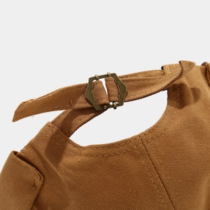 Detail of adjustable metal buckle and durable brown canvas fabric on docker cap