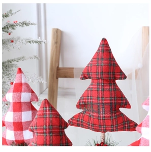 Close-up of fabric Christmas tree figurines with red plaid patterns and pine cone base