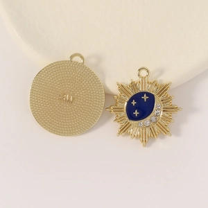 Detailed view of astronaut-themed gold charms with blue enamel moon and small crystals