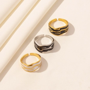 Three minimalist vintage 304 stainless steel open rings with black and white enamel wavy textures