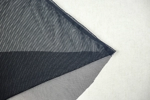 Close-up of semi-transparent black mesh fabric showing fine grid texture and breathability