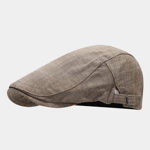 Detail view of khaki linen flat cap with adjustable metal buckle and textured fabric