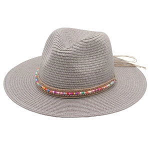 Detail of grey straw Panama hat featuring colorful beads and rhinestone trim on the band